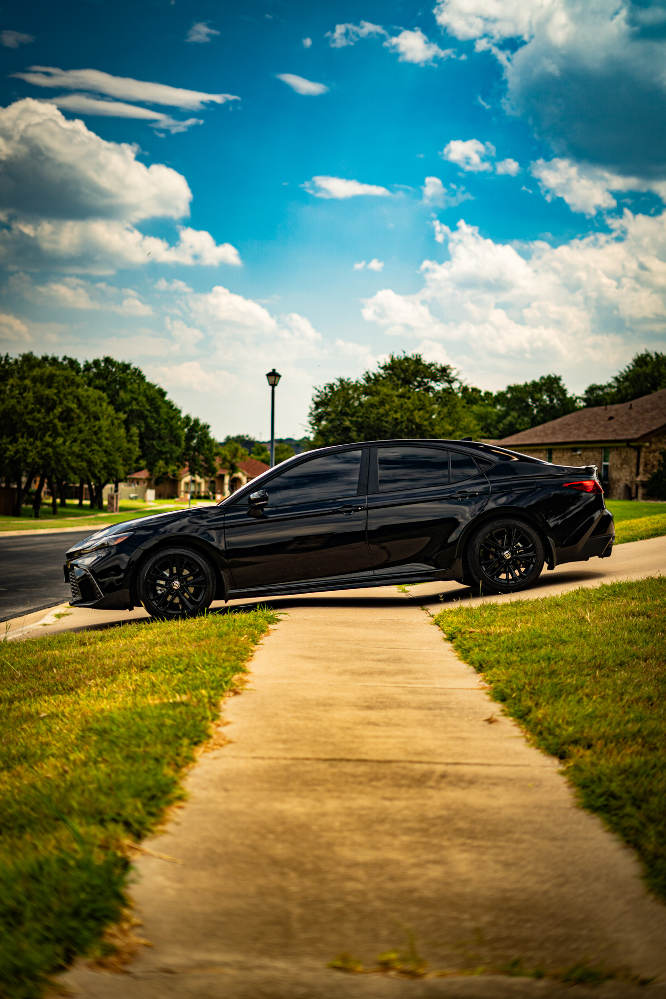 Window tint on black Toyota Camry — blacked-out side profile, Killeen TX