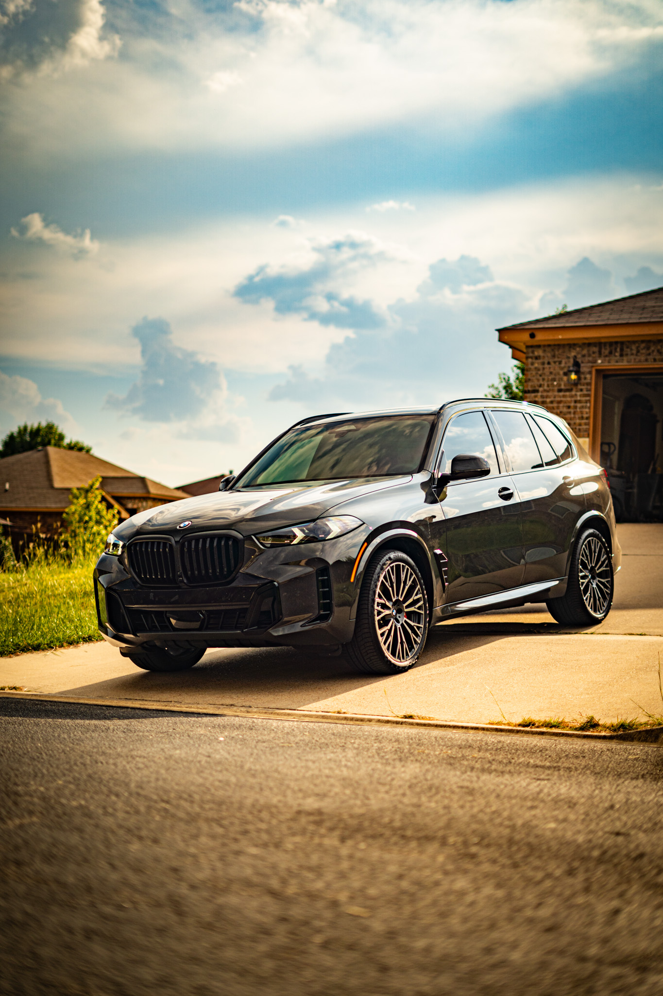 Ceramic tint on black BMW X5 — front three-quarter view, Chroma Auto Lab