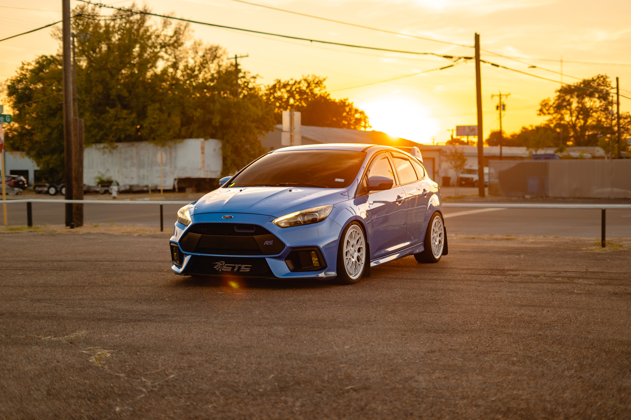 Window tint on blue Ford Focus RS hatchback — sunset shoot, Killeen TX