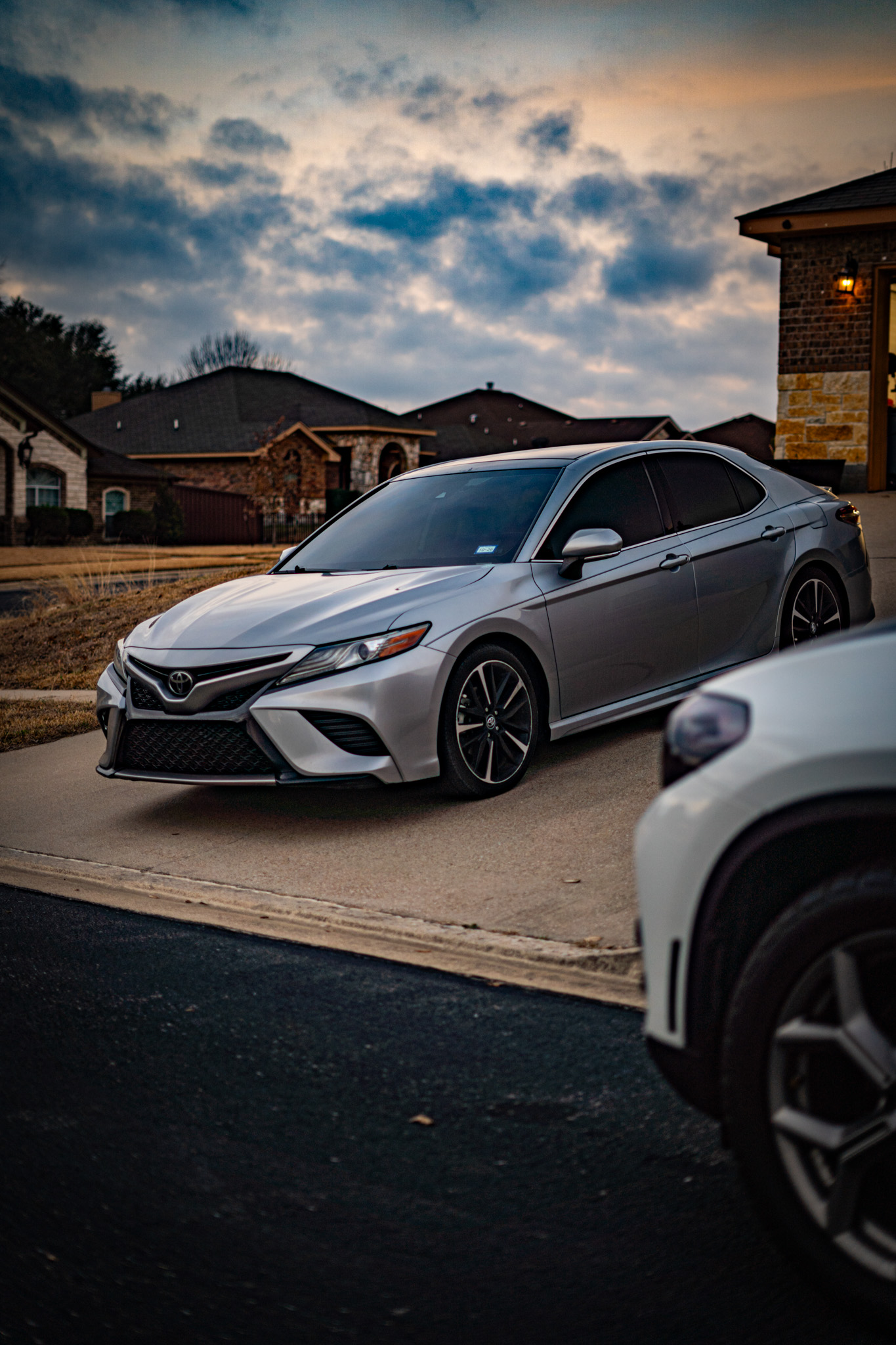 Window tint on silver Toyota Camry — front angle at dusk, Killeen TX