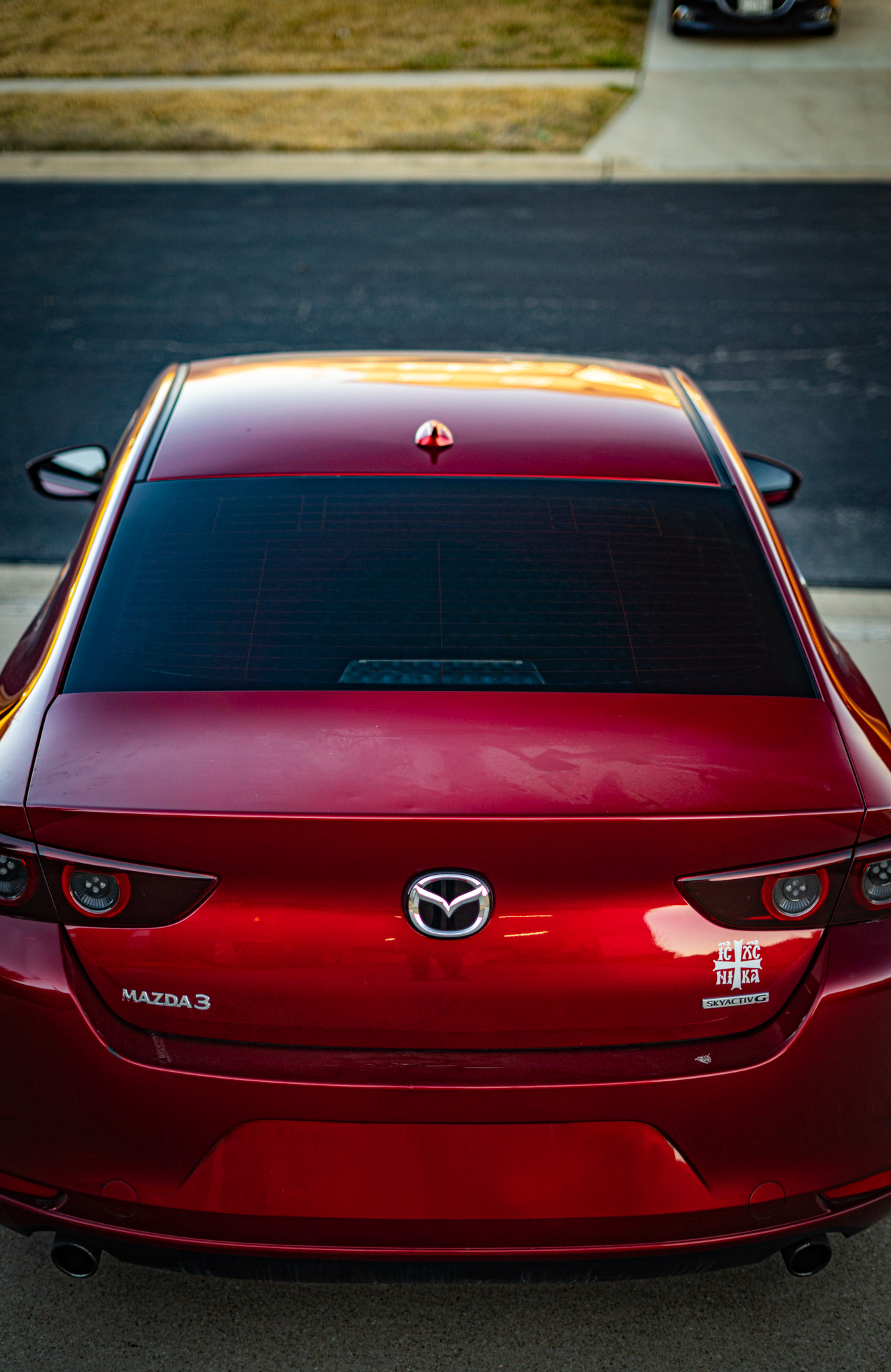 Window tint on red Mazda 3 — rear view showing tinted back glass, Chroma Auto Lab