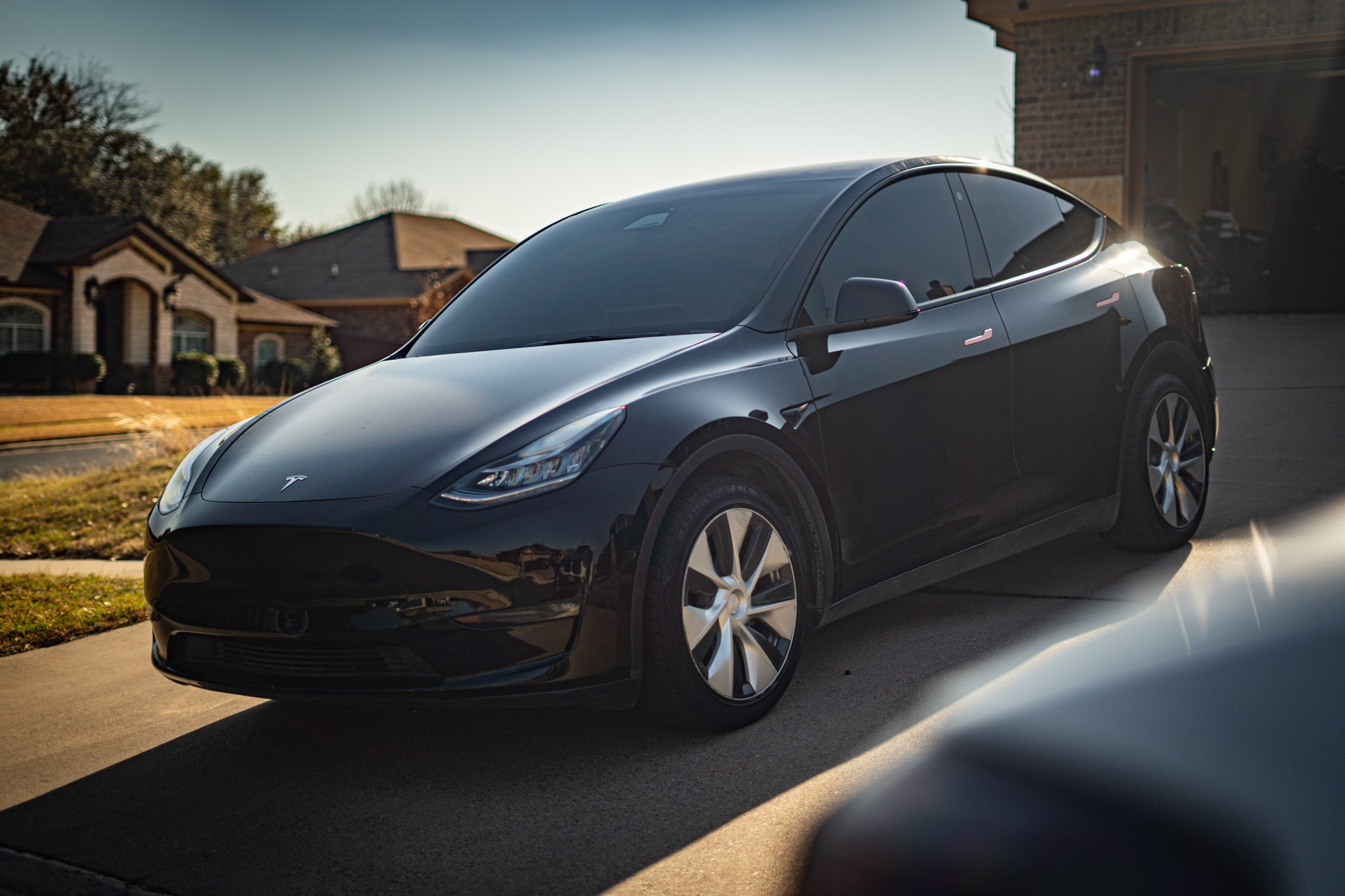 Window tint on black Tesla Model Y — front three-quarter view, Chroma Auto Lab