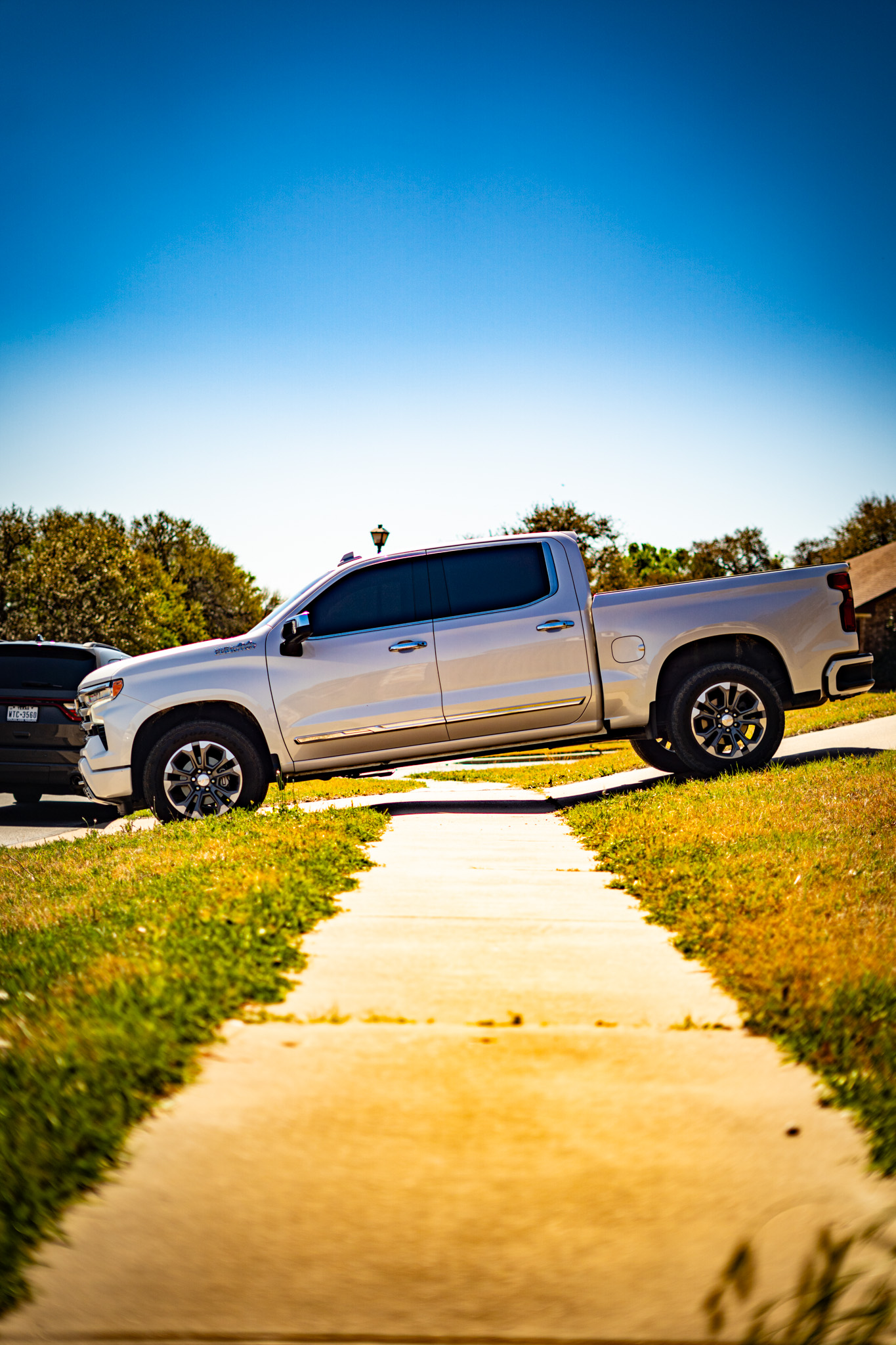 Ceramic tint on silver Chevrolet Silverado — side profile, Chroma Auto Lab