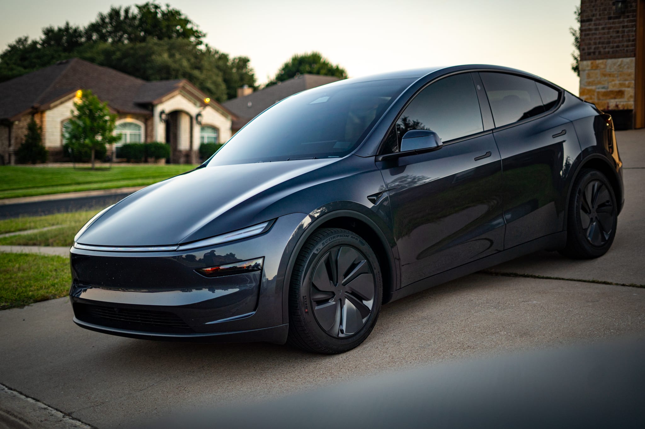 Window tint on a graphite Tesla Model Y at dusk