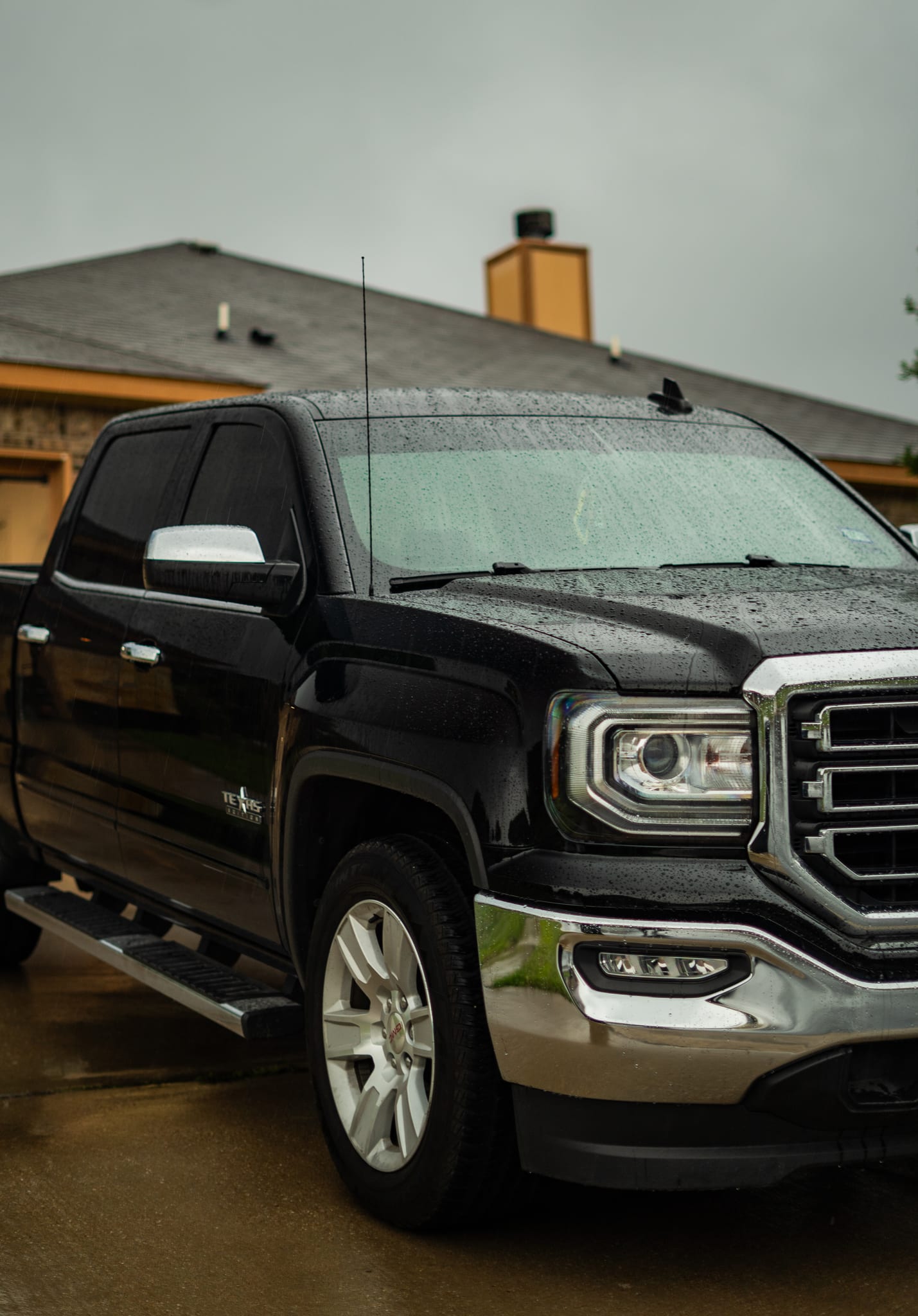Window tint on a black GMC Sierra after the rain